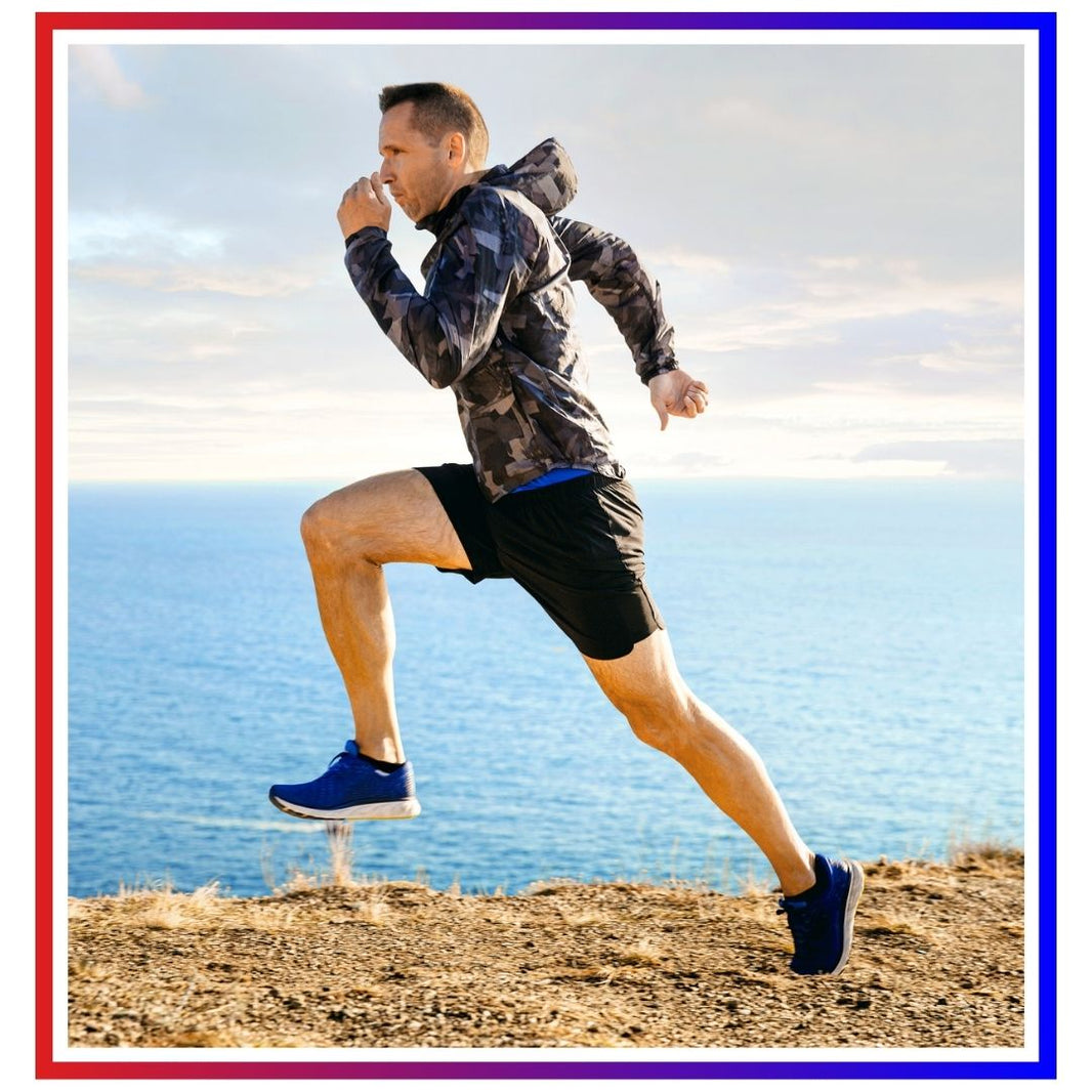 Man trail running along coastal cliff path